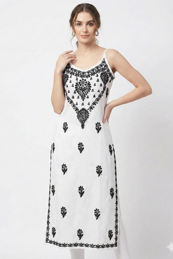 Woman wearing a white dress with black floral patterns on a white background